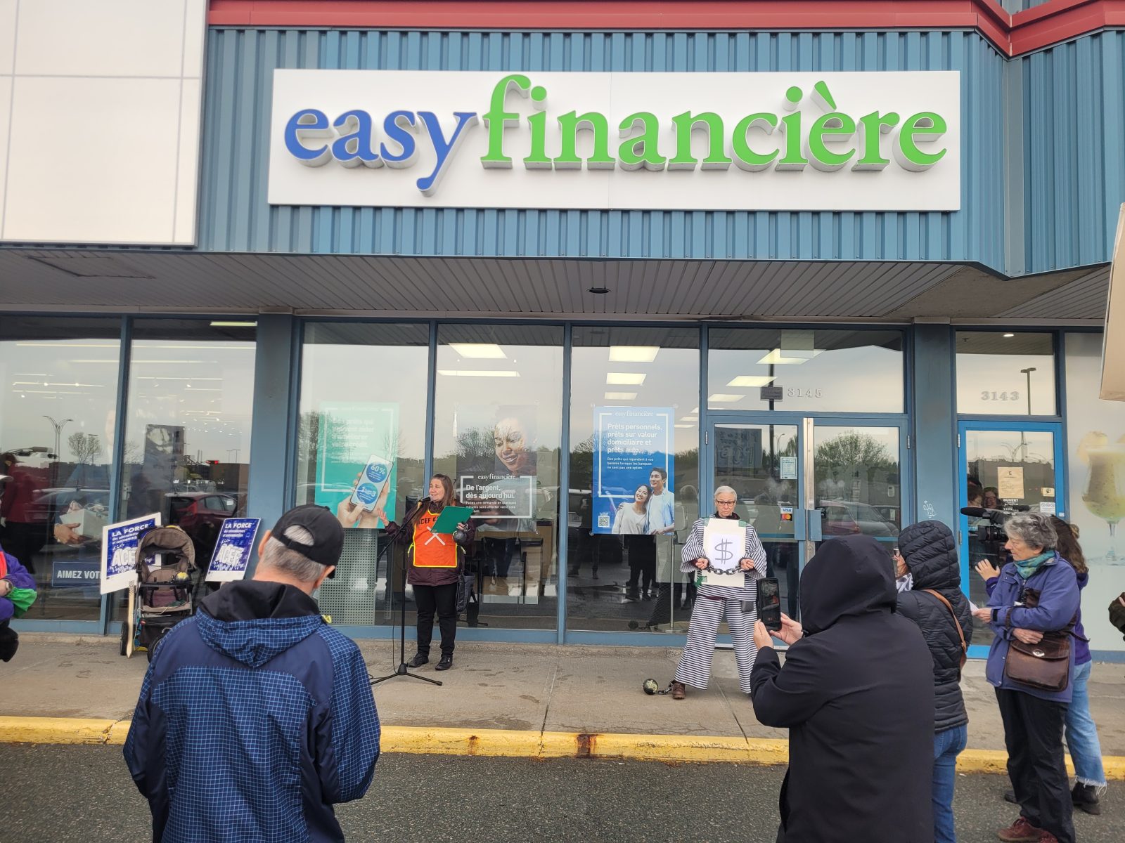 Protesters rally outside easyfinancière in opposition to predatory lending